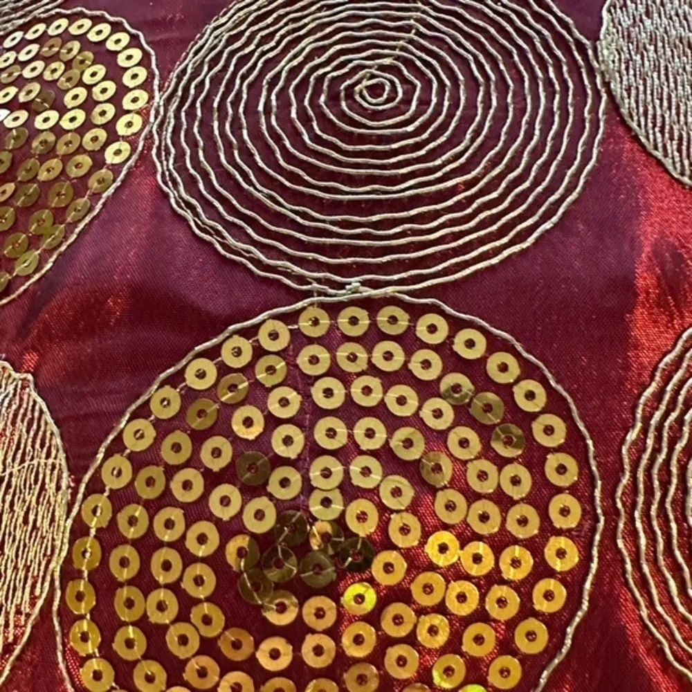 Dark red pillow with gold accents